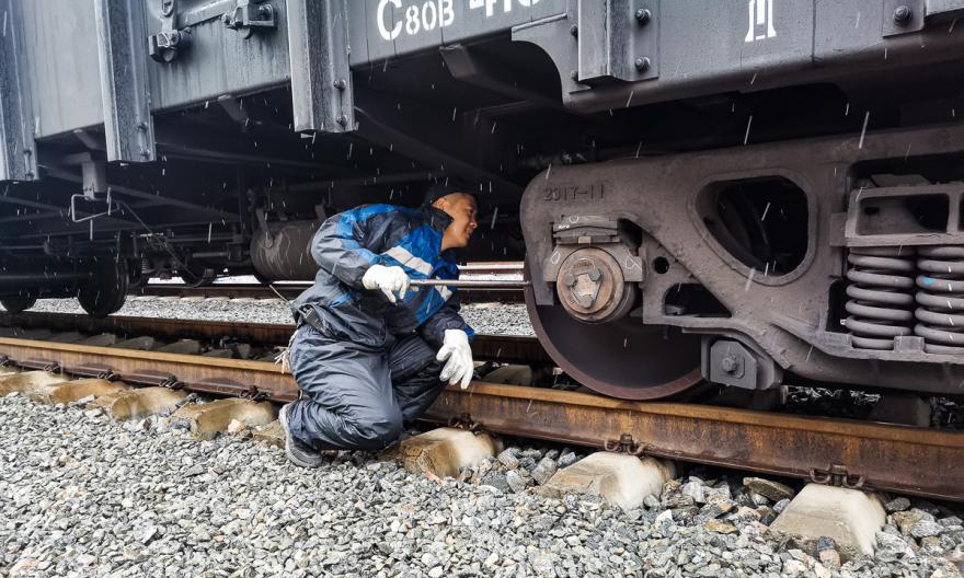 鐵路裝備包頭分公司員工正在冒雪進行列車檢修作業。（王嘉琦 攝）