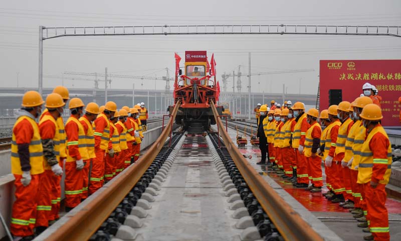 12月16日，在杭州西站西咽喉區(qū)湖杭鐵路施工現(xiàn)場(chǎng)，首對(duì)500米長(zhǎng)鋼軌被安全平穩(wěn)地鋪設(shè)到無(wú)砟軌道道床上，標(biāo)志著湖杭鐵路正式進(jìn)入全線(xiàn)鋪軌階段。圖為中鐵四局施工人員在湖杭鐵路上進(jìn)行鋪軌作業(yè)。（新華社記者 黃宗治 攝）