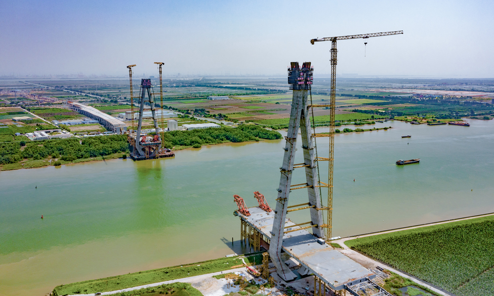 9月6日，中國中鐵旗下中鐵大橋局承建的南（廣州南沙）中（中山）高速公路洪奇門特大橋西主塔封頂，比計劃工期提前30天。該橋跨越洪奇瀝水道，是粵港澳大灣區(qū)重大交通基礎(chǔ)設(shè)施項目南中高速公路的控制性工程。大橋全長1126米，為雙塔雙索面半漂浮體系鋼箱梁斜拉橋，主跨520米，橋面寬43.2米。主塔為鉆石型混凝土索塔，呈八角形截面，塔冠為“木棉花”造型。圖為洪奇門特大橋東西主塔。