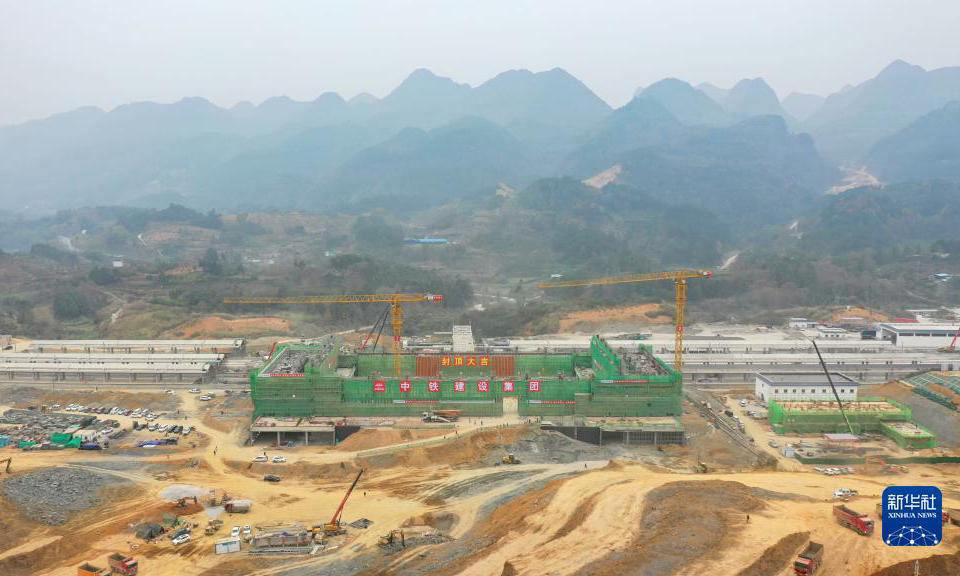 12月12日，隨著最后一方混凝土澆筑完成，由中鐵建設(shè)集團(tuán)承建的貴南高鐵荔波站站房主體結(jié)構(gòu)順利封頂。據(jù)了解，荔波站位于貴州省荔波縣朝陽鎮(zhèn)境內(nèi)，距離著名世界自然遺產(chǎn)地小七孔景區(qū)僅約15公里，開通后將大大方便旅客前往游玩。貴南高鐵連接貴州貴陽和廣西南寧，是我國“八縱八橫”高速鐵路網(wǎng)包海通道的組成部分，設(shè)計時速350公里。圖為荔波站站房成功封頂（無人機(jī)照片）。新華社記者 劉續(xù) 攝