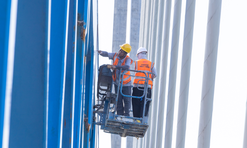 圖為施工人員進行鋼桁梁焊縫檢測。