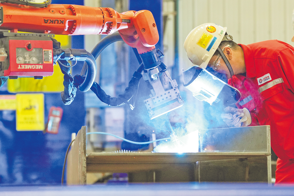 近日，中國(guó)海油下屬海油工程發(fā)布消息，國(guó)內(nèi)首批自主研發(fā)海洋工程柔性制造智能焊接機(jī)器人設(shè)備系統(tǒng)在天津集成完工，進(jìn)入測(cè)試驗(yàn)收階段，標(biāo)志著我國(guó)海洋油氣裝備關(guān)鍵節(jié)點(diǎn)柔性制造技術(shù)取得重大突破，對(duì)加快培育發(fā)展海洋能源新質(zhì)生產(chǎn)力具有重要意義。 圖為工作人員近距離觀察焊縫細(xì)節(jié)。