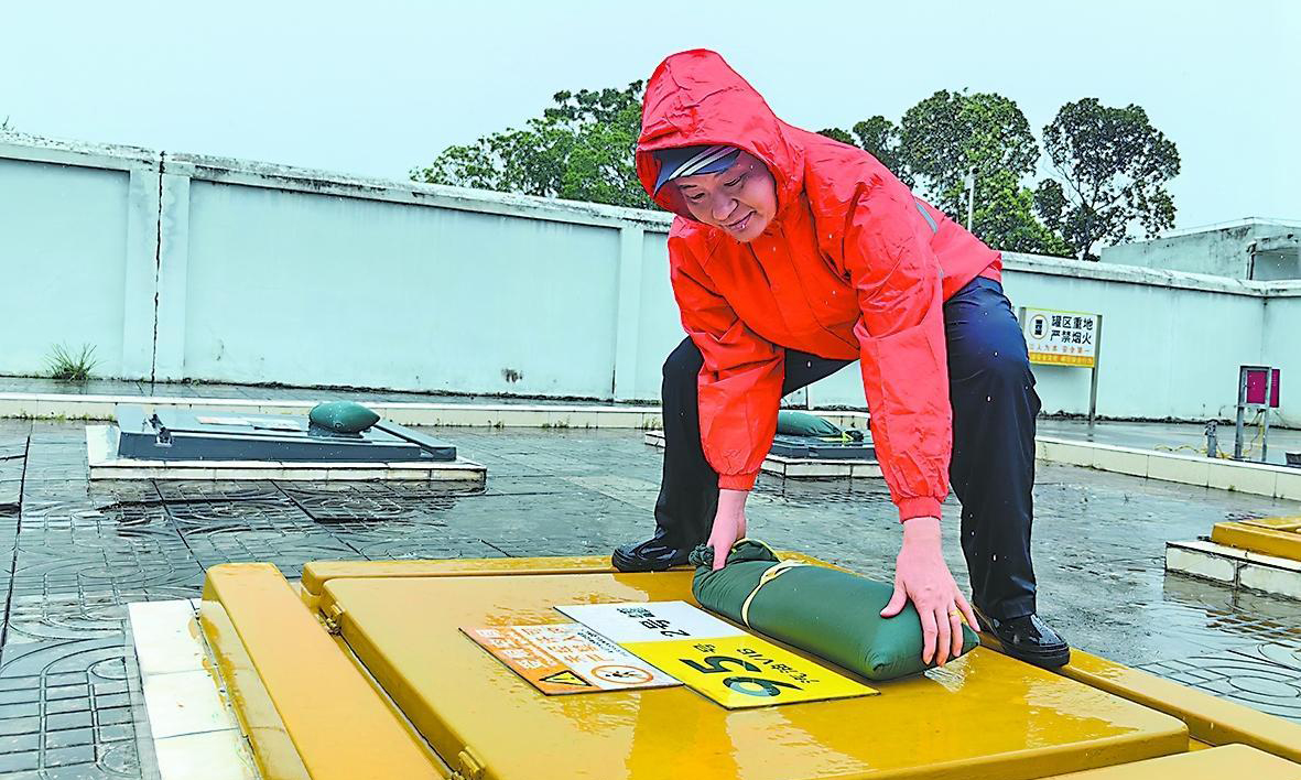 海南石油萬寧萬州加能站工作人員為油罐區(qū)操作井蓋增設(shè)防風(fēng)沙袋。